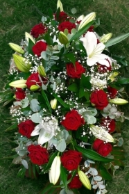 Funeral coffin spray red roses and lilies